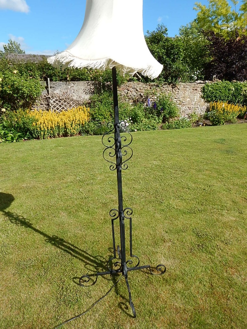 Appraisal: A wrought iron standard lamp with square section column and