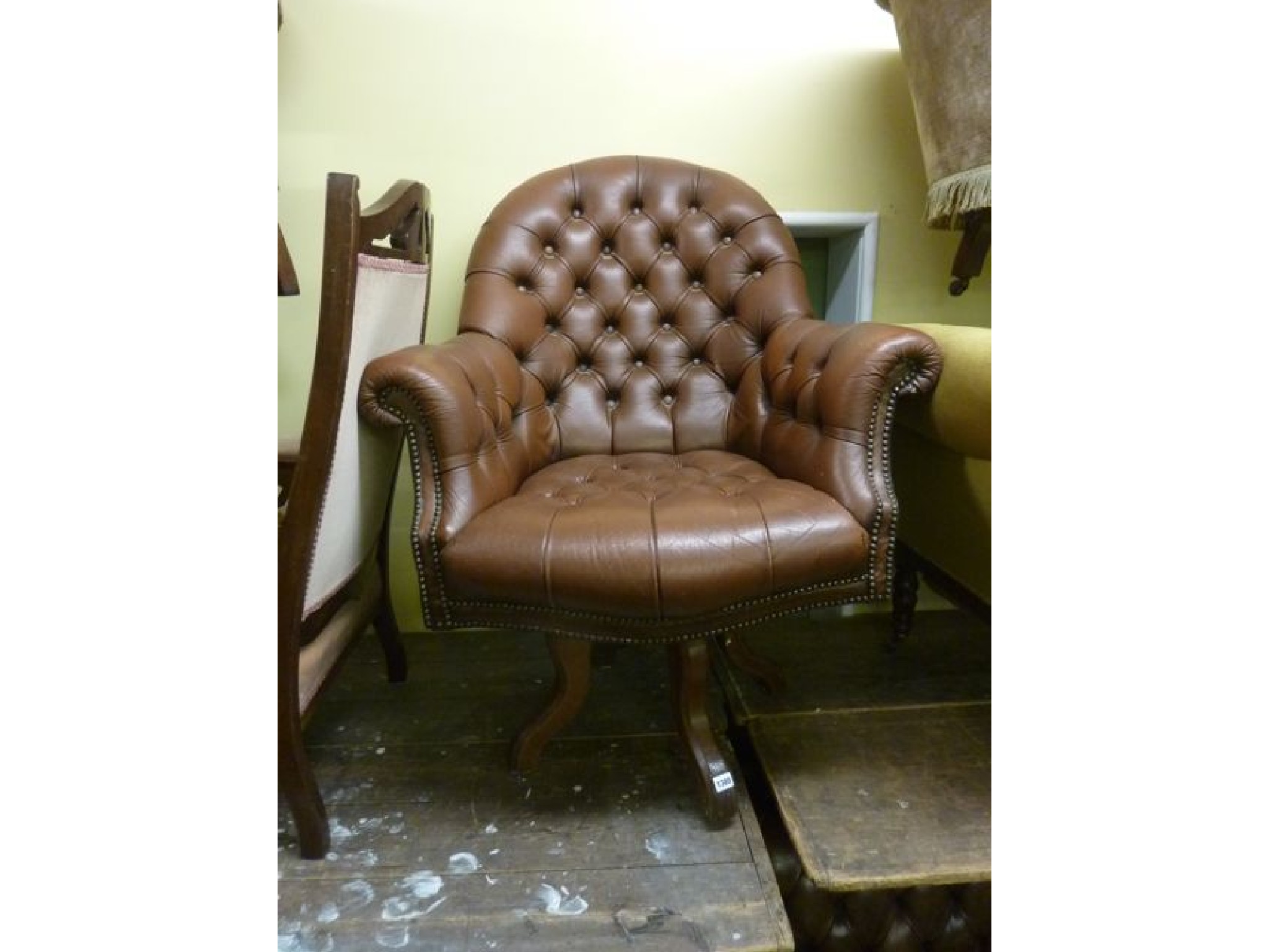 Appraisal: A substantial office chair upholstered in brown leather with deep