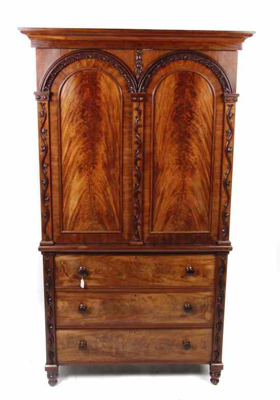 Appraisal: A Continental Walnut Linen Press having a molded cornice over