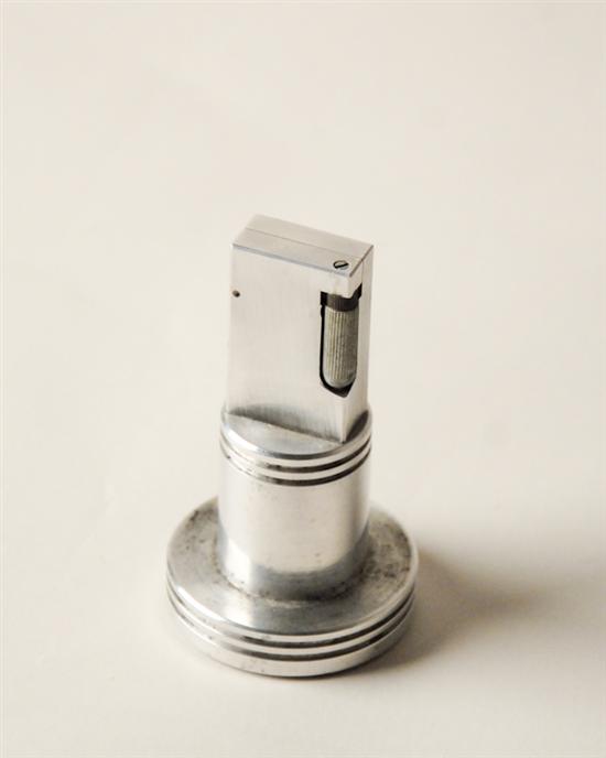 Appraisal: An E th C Aluminum Cigarette Lighter round flat base