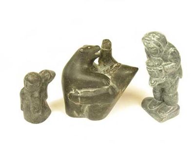 Appraisal: An Inuit carved soapstone group of a native attacking a