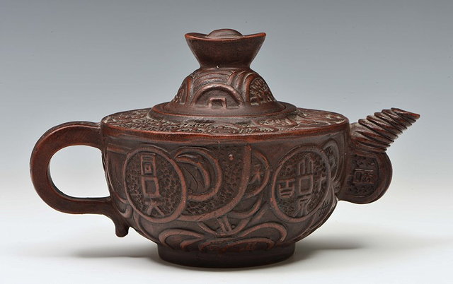 Appraisal: A YIXING TEAPOT with raised panels and reeded spout Qianlong