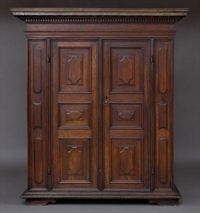 Appraisal: CONTINENTAL BAROQUE-STYLE WALNUT ARMOIRE The molded dentil-carved cornice above a