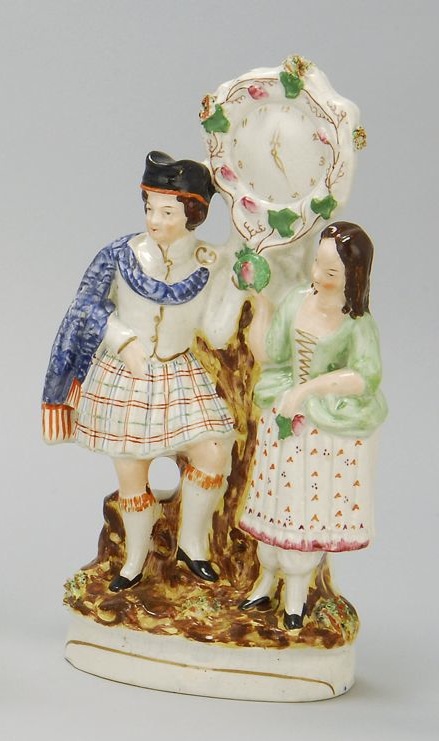 Appraisal: STAFFORDSHIRE POLYCHROME FIGURAL CLOCK GROUP Circa Full relief Scottish couple