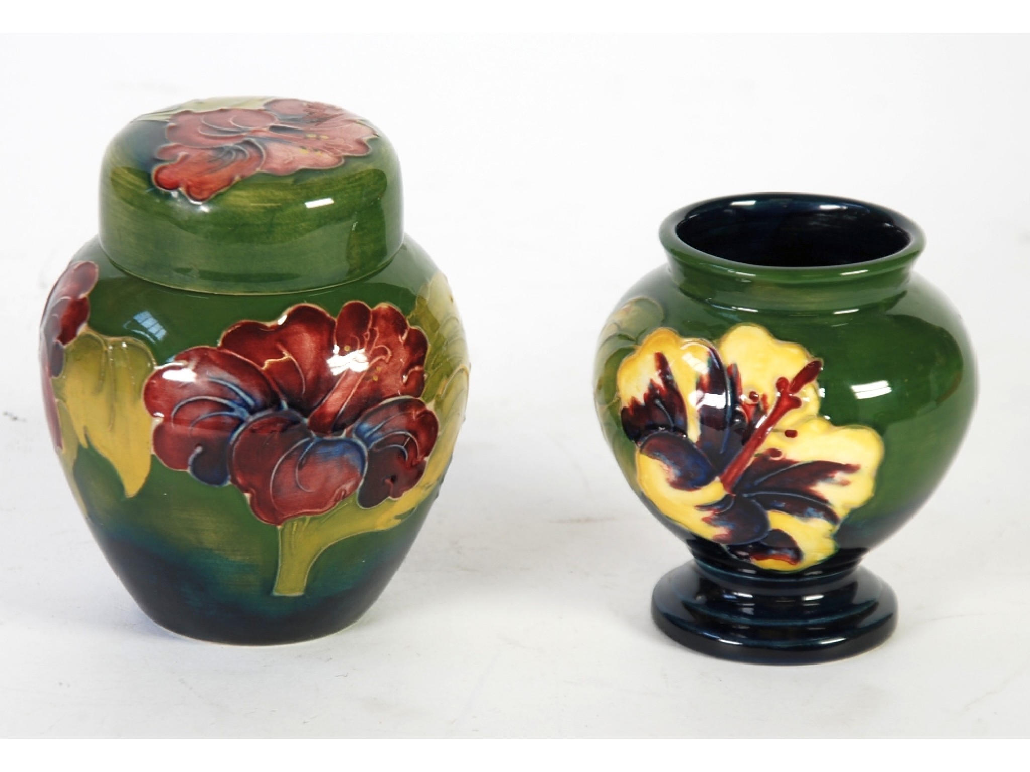 Appraisal: A WALTER MOORCROFT HIBISCUS PATTERN TUBE LINED POTTERY GINGER JAR