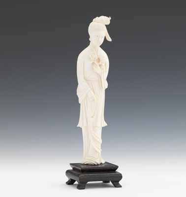 Appraisal: A Carved Ivory Figure of Quanyin Depicted standing up holding