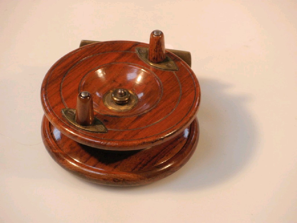 Appraisal: A brass and mahogany star back fishing reel