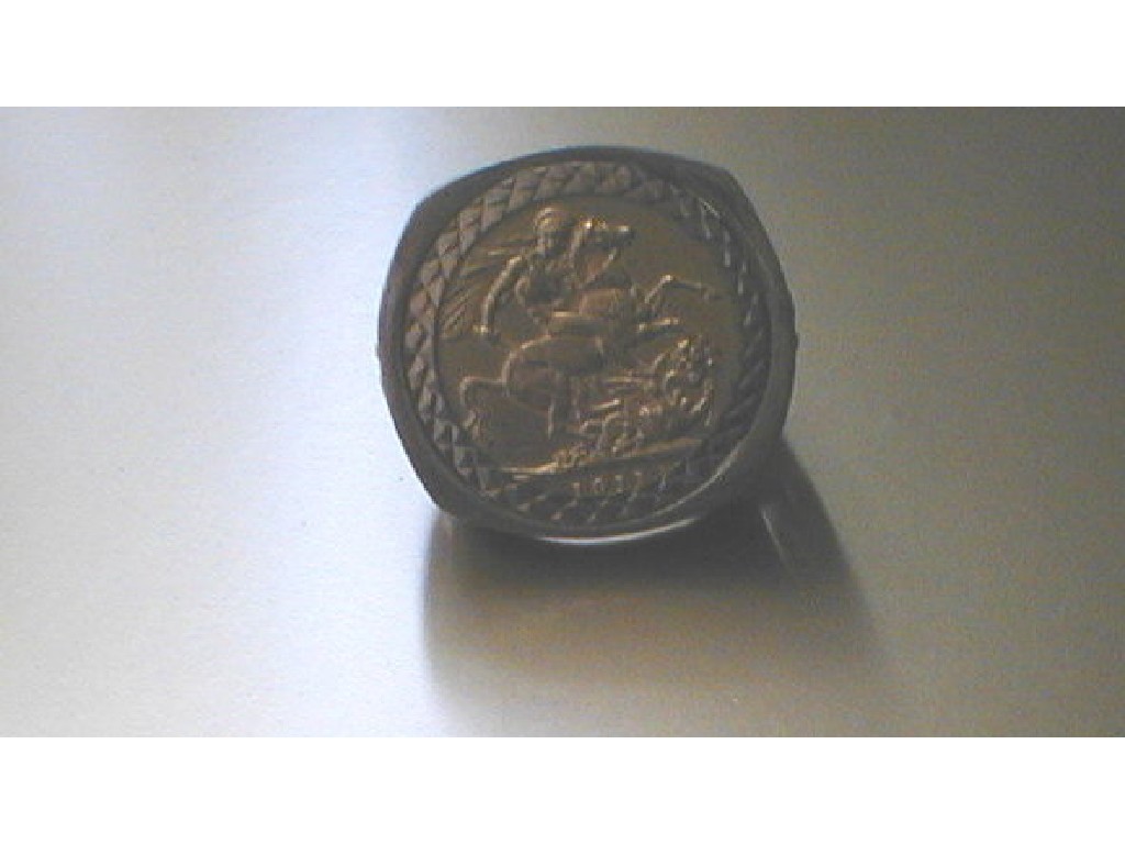 Appraisal: A sovereign in a large gents ct gold ring mount