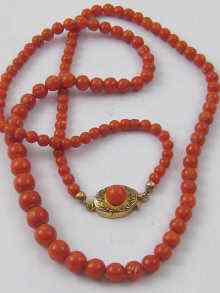 Appraisal: A graduated coral bead necklace of good colour the largest