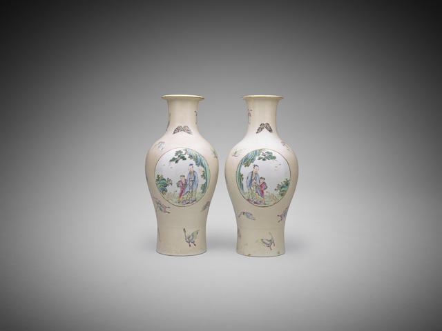 Appraisal: A near pair of Chinese reserve-painted famille-rose vases Qianlong iron-red