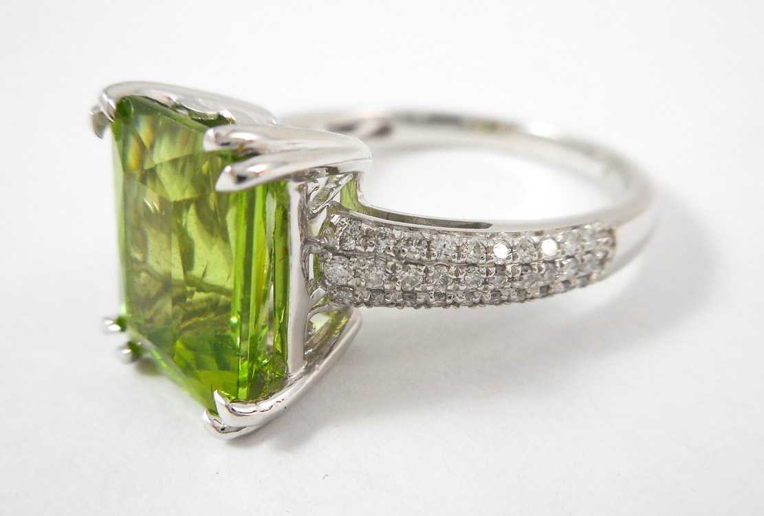 Appraisal: PERIDOT DIAMOND AND FOURTEEN KARAT GOLD RING The white gold