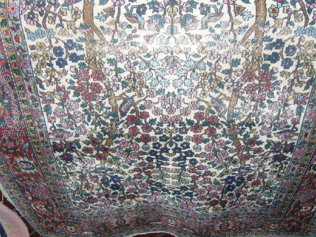 Appraisal: A Persian rug the white field detailing birds and flowering