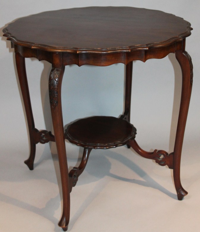 Appraisal: An Edwardian mahogany window table the piecrust top raised on