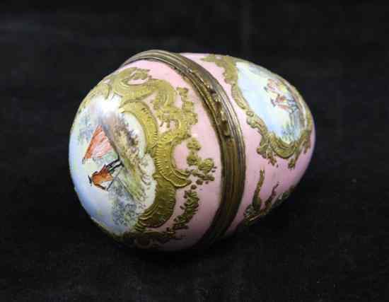 Appraisal: A th century Viennese enamelled egg decorated with three vignettes