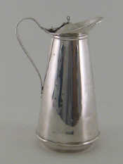 Appraisal: An Arts Crafts silver hot water jug with insulated white