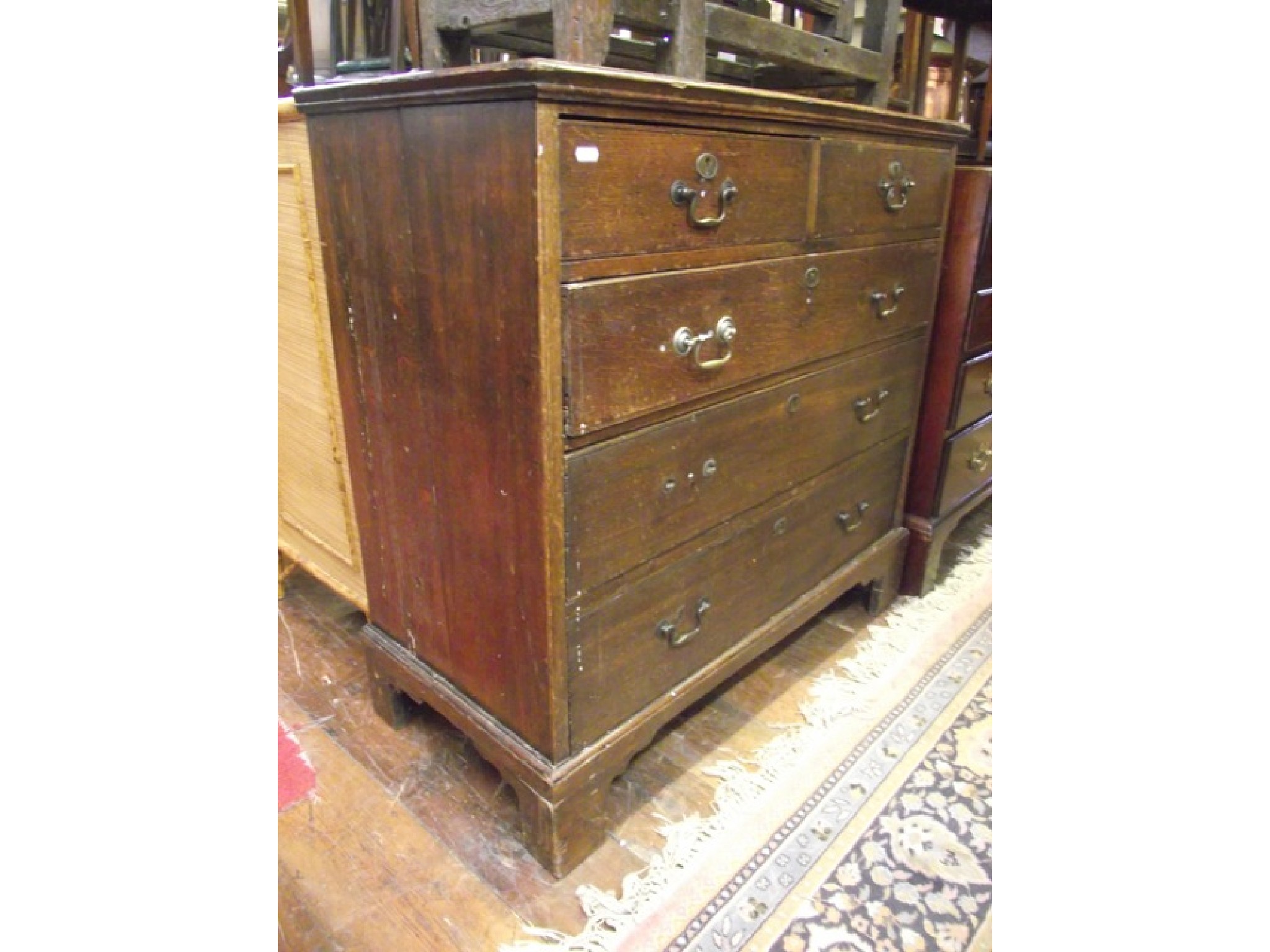 Appraisal: A Georgian oak country made chest of three long and