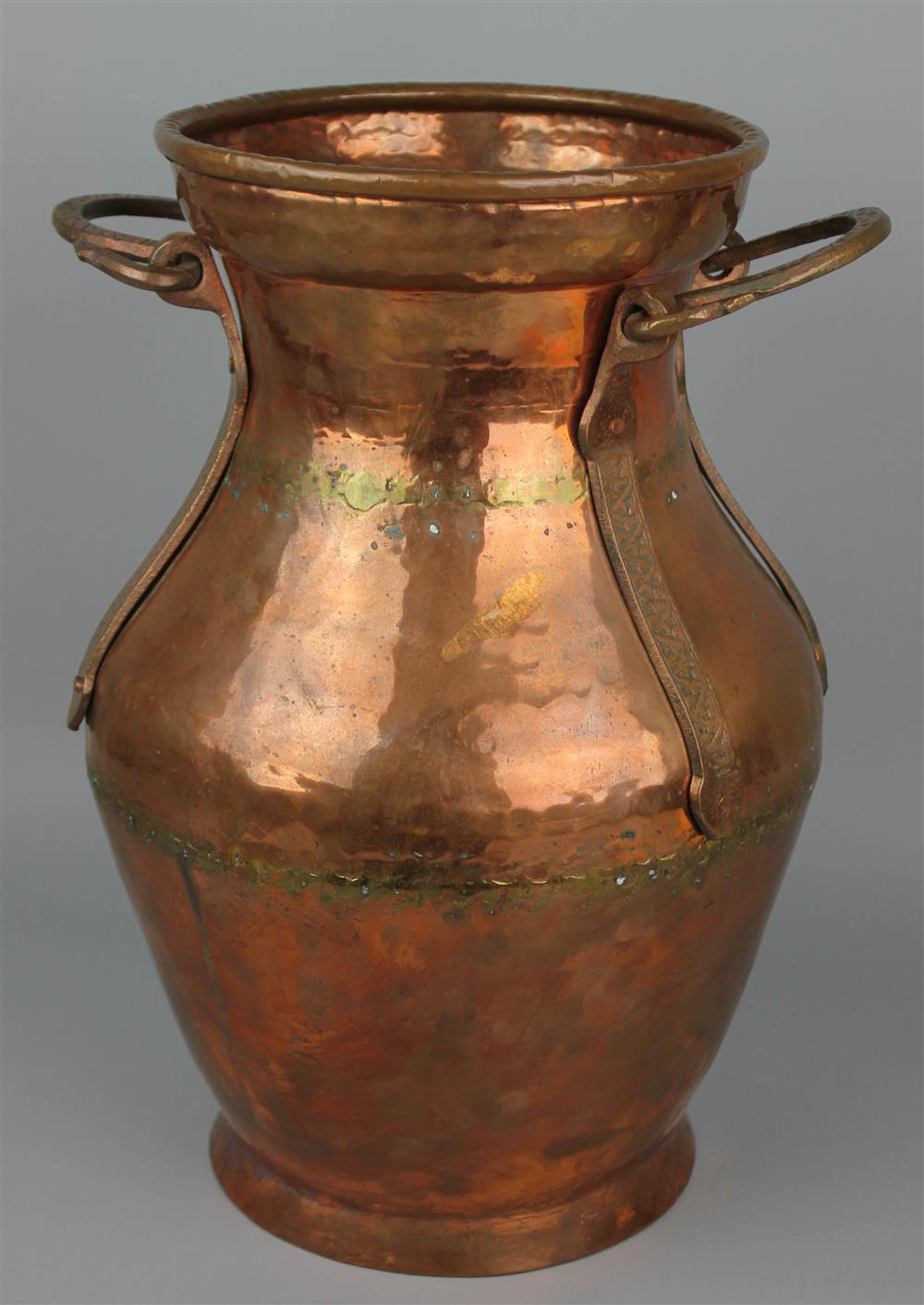 Appraisal: HAMMERED COPPER TWO-HANDLED VESSEL with U-shaped swing handles on applied