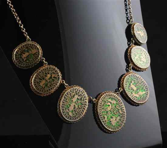 Appraisal: An Indian gold mounted necklace with seven graduated green foil