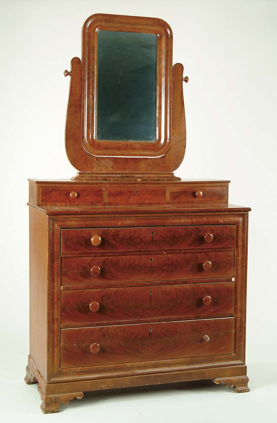 Appraisal: THREE OVER FOUR DRAWER MIRROR TOP EMPIRE MAHOGANY CHEST U-shaped