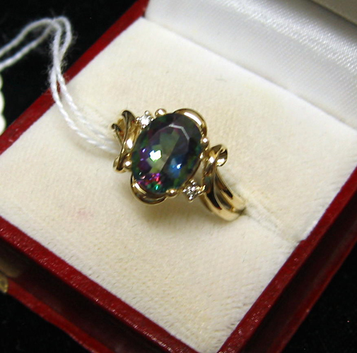 Appraisal: MYSTIC TOPAZ DIAMOND AND FOURTEEN KARAT GOLD RING centering an