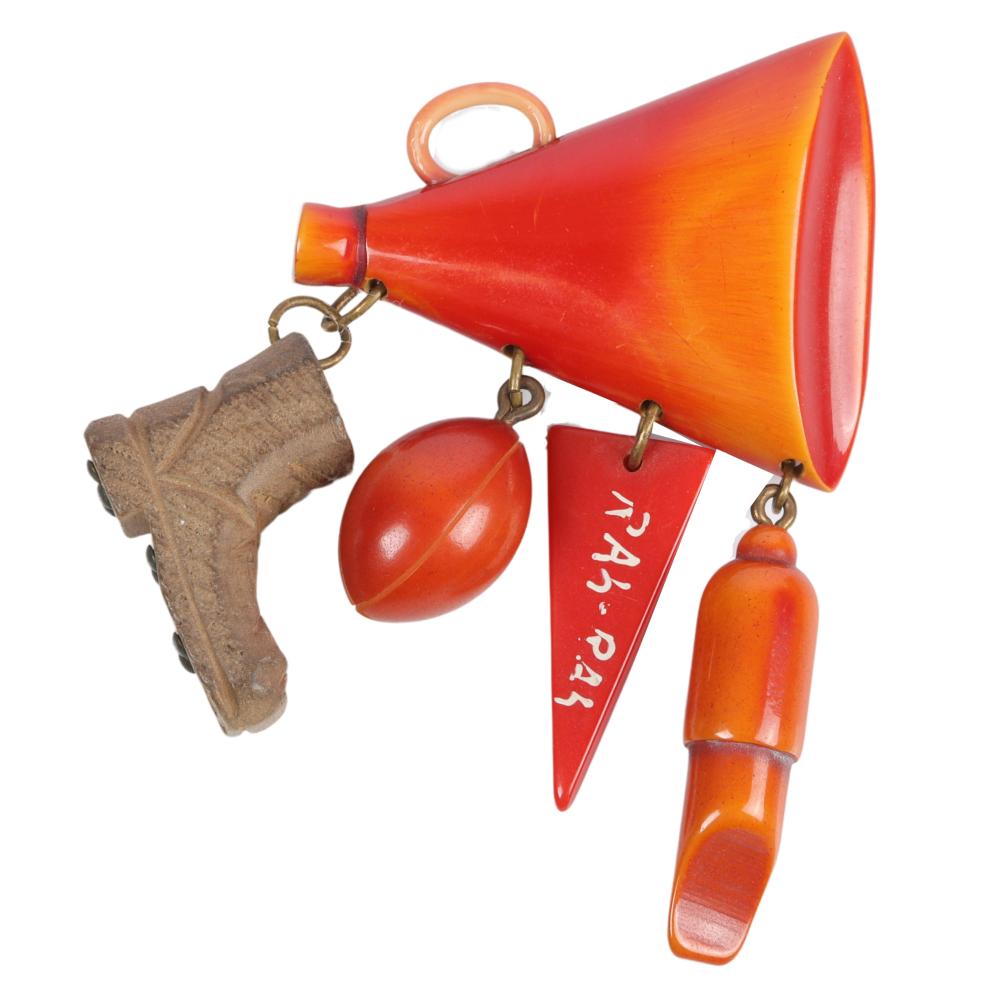 Appraisal: BAKELITE OVER-DYED MEGAPHONE FOOTBALL CHARMS PIN WITH X Bakelite over-dyed