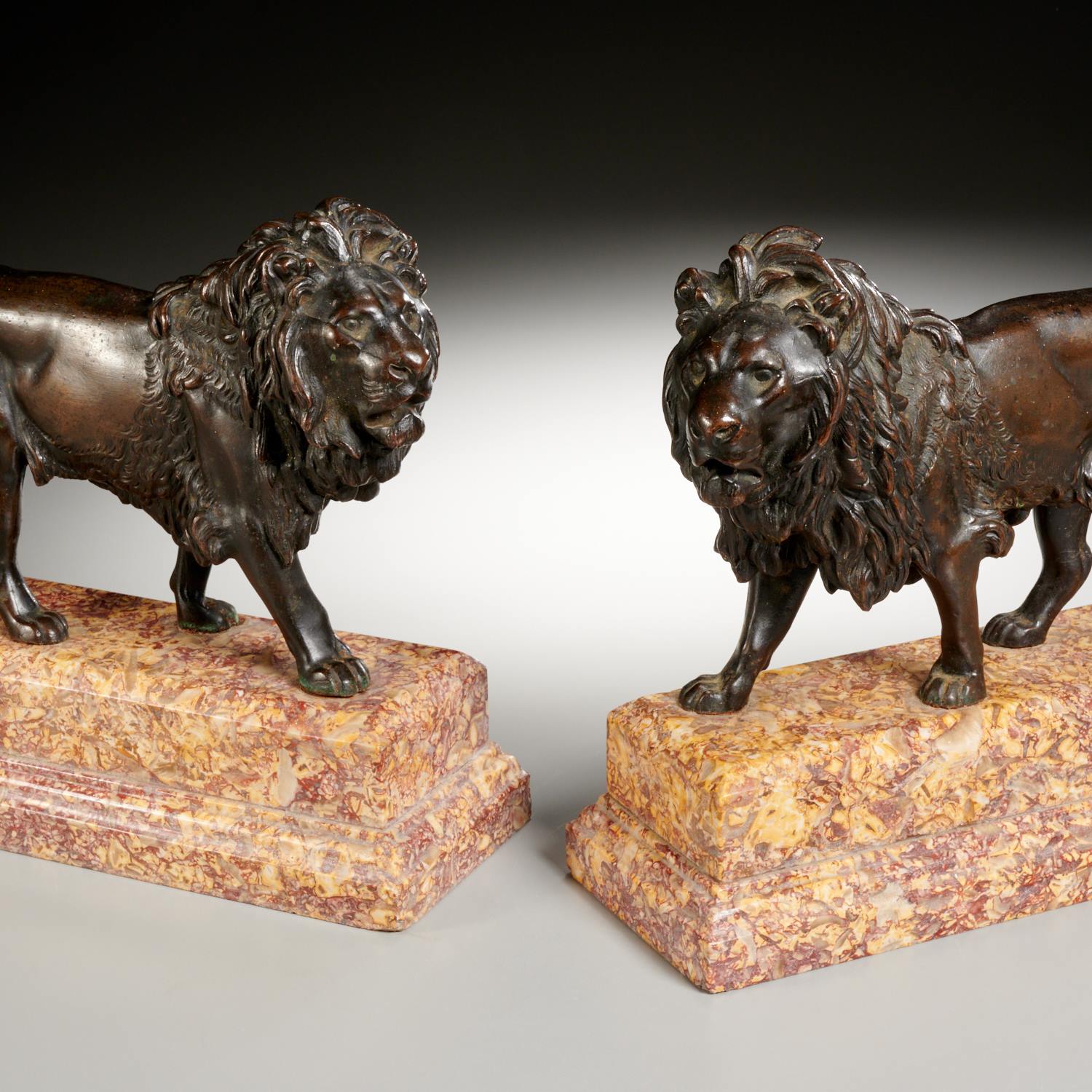 Appraisal: CONTINENTAL SCHOOL PAIR BRONZE LIONS c likely French dark patinated