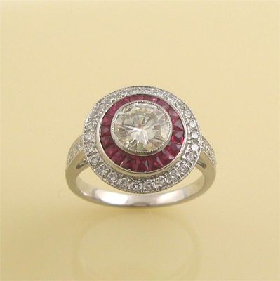 Appraisal: A diamond and ruby cluster ring The circular cut diamond