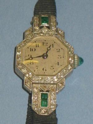 Appraisal: AN EDWARDIAN DIAMOND AND EMERALD COCKTAIL WATCH the octagonal silvered