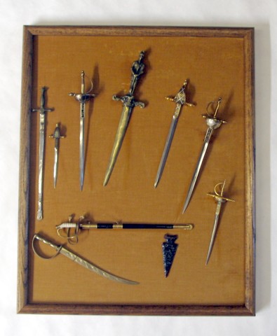 Appraisal: DISPLAY OF MINIATURE SWORDS AND OBSIDIAN ARROW HEAD five swords