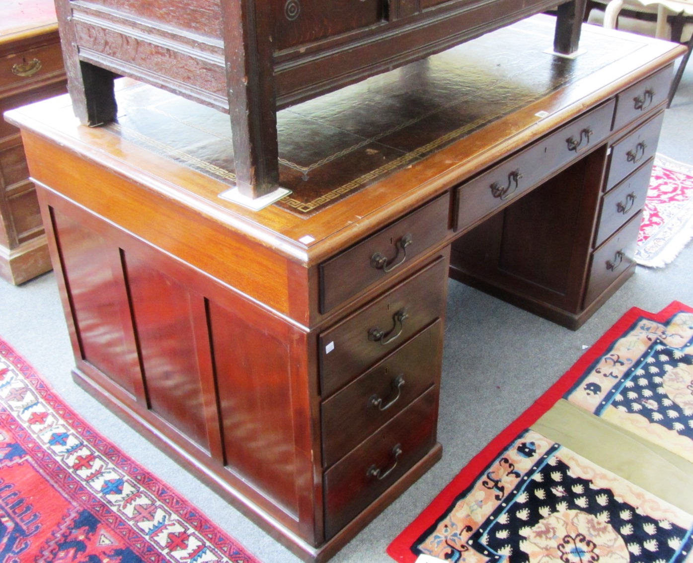 Appraisal: An th century style mahogany pedestal desk with nine drawers