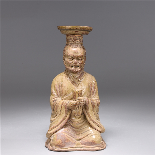 Appraisal: Unique Chinese molded and parcel-glazed pottery figural candlestick of well