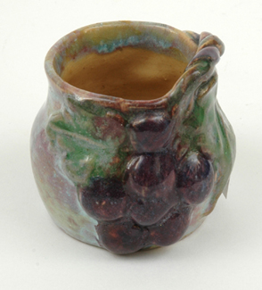 Appraisal: UNA DEERBON Victoria circa Globular earthenware vase applied grape and