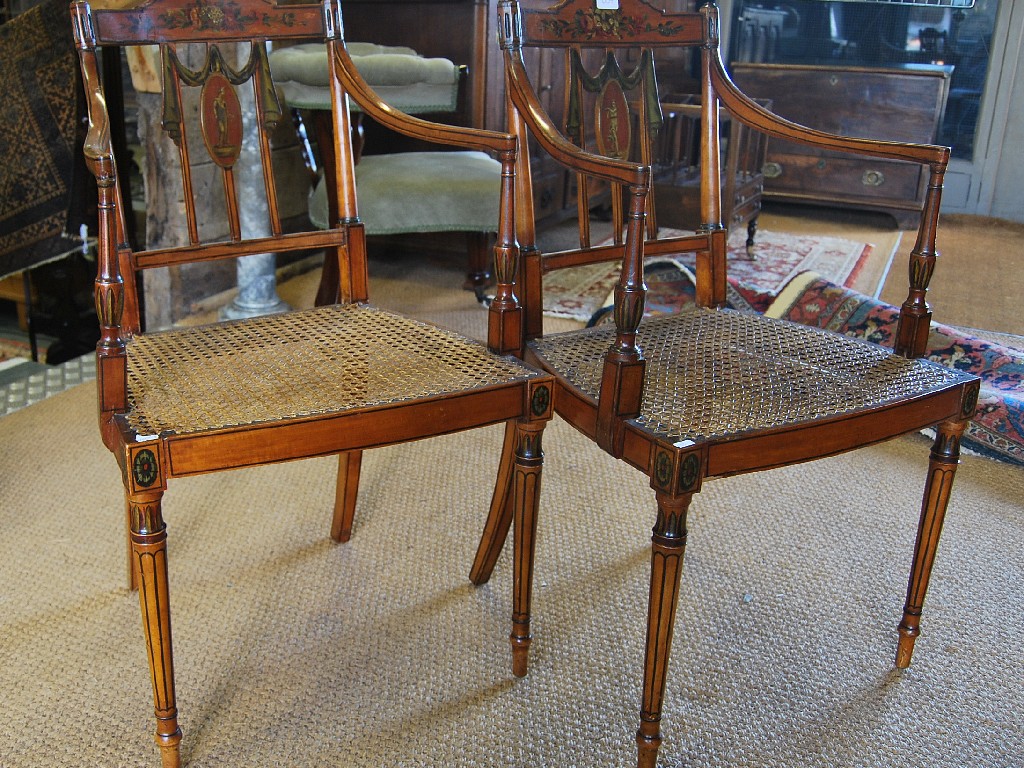 Appraisal: A pair of Sheraton Revival satinwood open armchairs decorated in