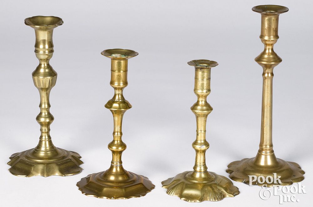 Appraisal: Four Queen Anne scalloped base candlesticks mid Four Queen Anne