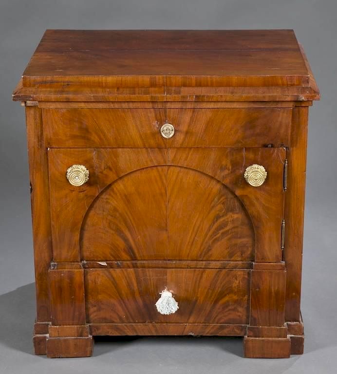 Appraisal: Neoclassical storage cabinet A neoclassical walnut pot cupboard th century