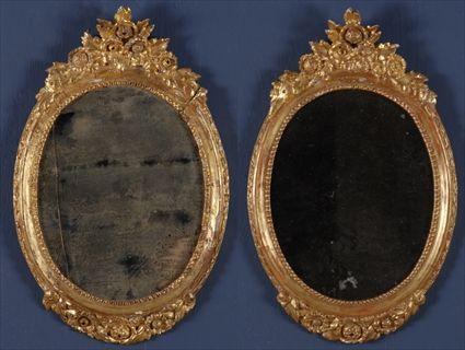 Appraisal: PAIR OF LOUIS XVI-STYLE CARVED GILTWOOD MIRRORS Each oval plate