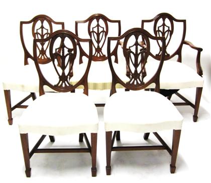 Appraisal: Five Federal-style carved mahogany shield back chairsIncluding two armchairs and