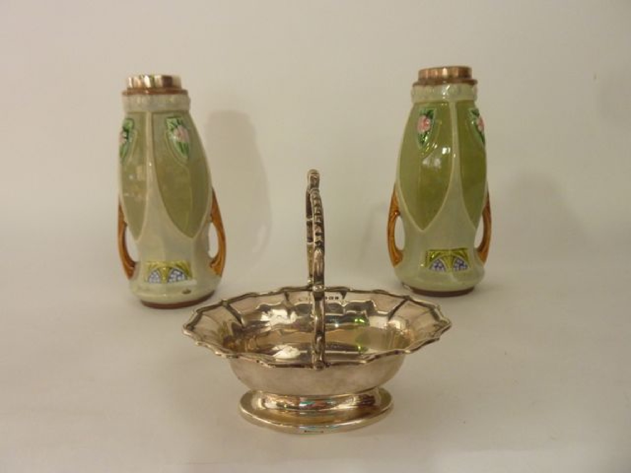 Appraisal: A pair of painted ceramic vases the silver rims hallmarked