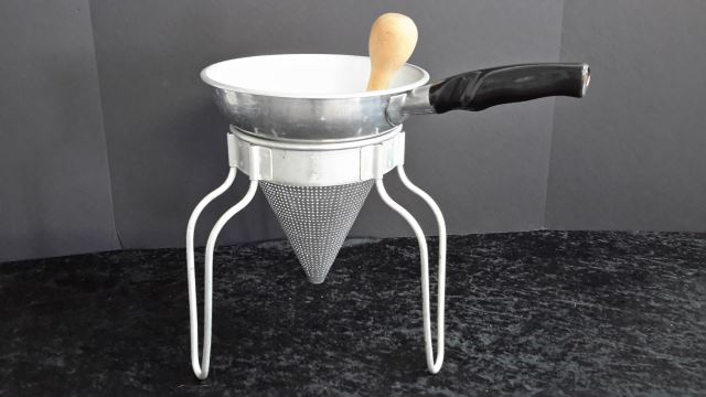 Appraisal: Wear-Ever Aluminum Cone Strainer and Wood Pestle Vintage aluminum cone