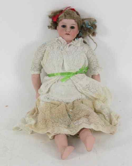 Appraisal: An Armand Marsielle bisque head doll with brown weighted eyes