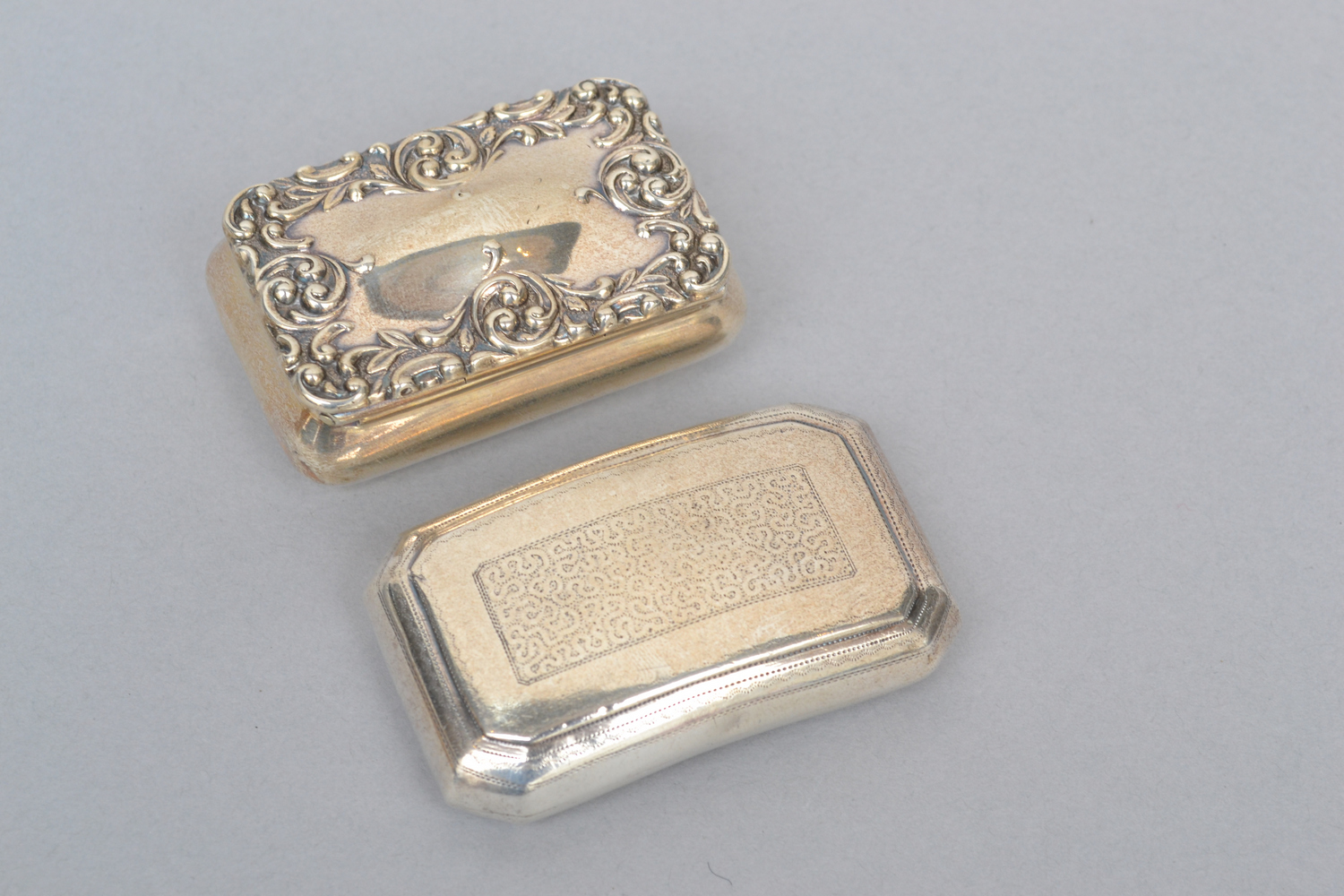 Appraisal: TWO STERLING SILVER SNUFF BOXES ONE WITH FLORAL EMBOSSED DECORATION