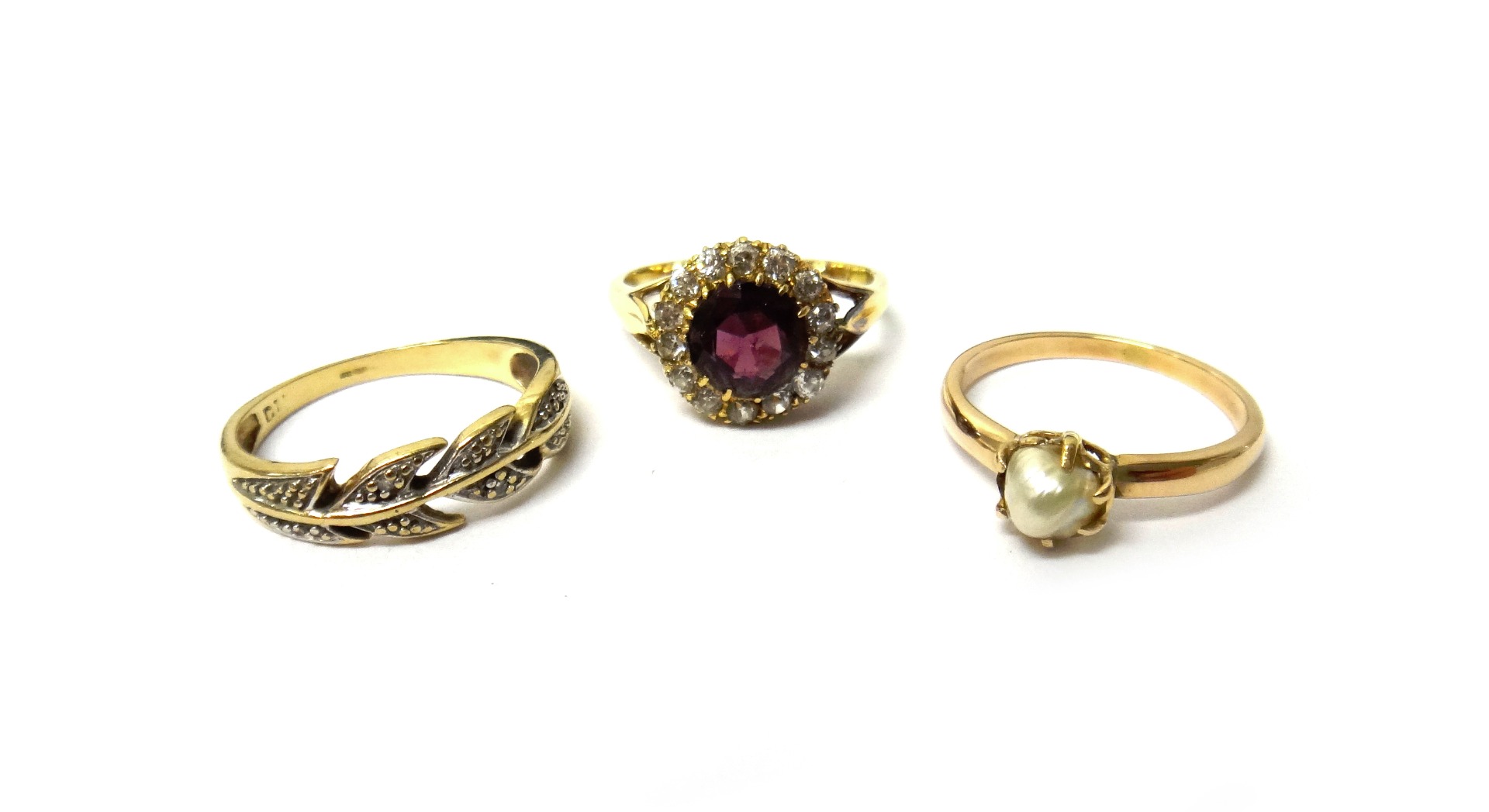 Appraisal: A gold garnet and diamond set cluster ring claw set