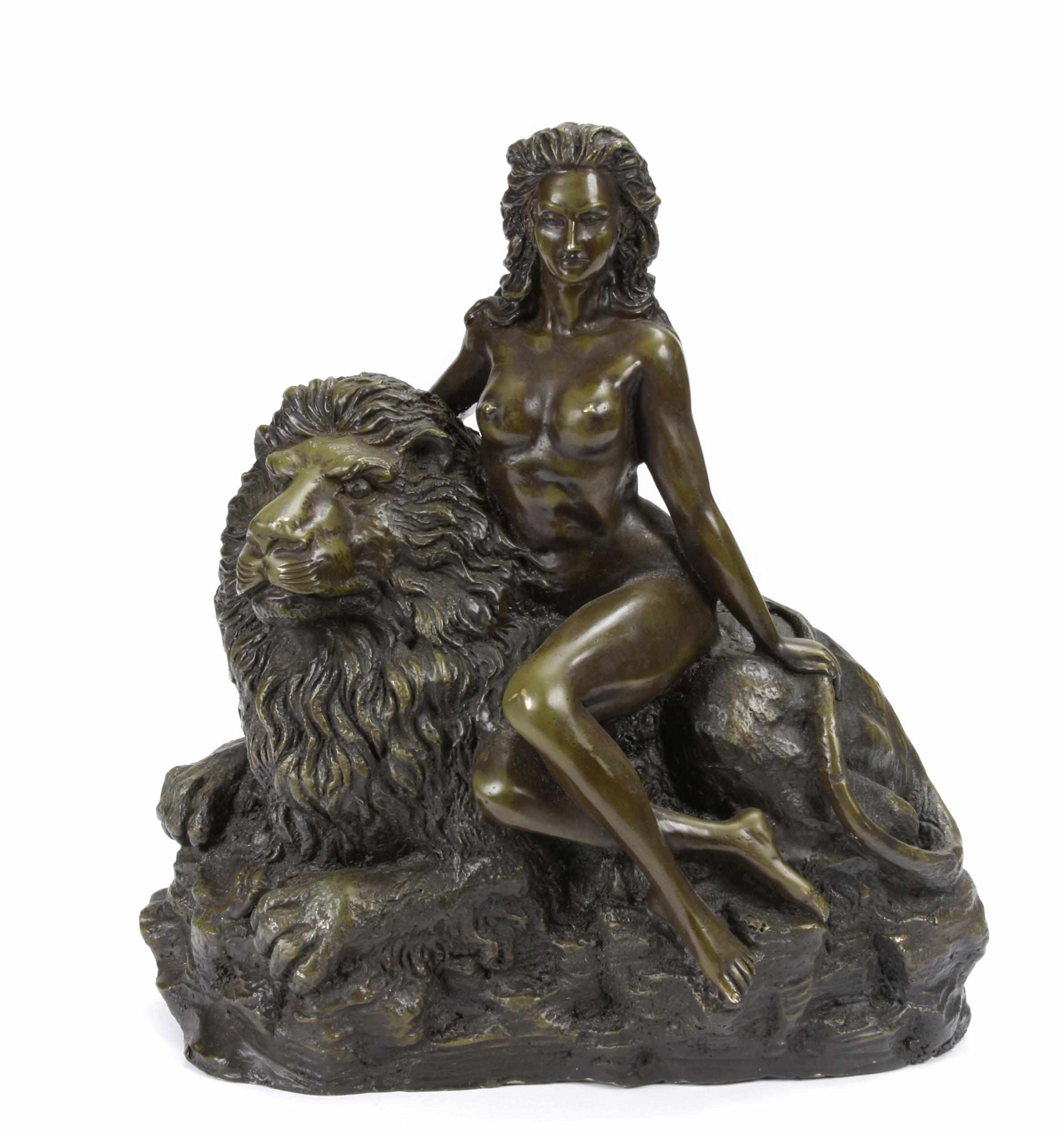 Appraisal: A patinated bronze figural group of woman and a lion