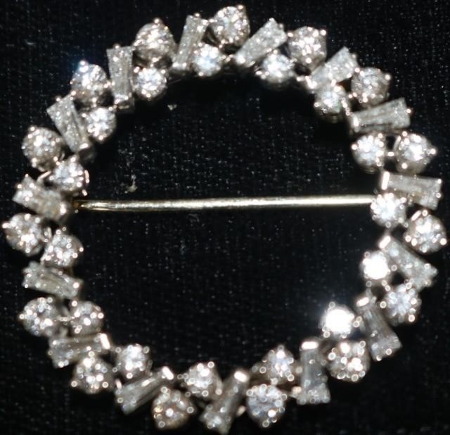 Appraisal: CARTIER PLATINUM AND DIAMOND ROUND PIN WITHROUND AND BAGUETTE SHAPED