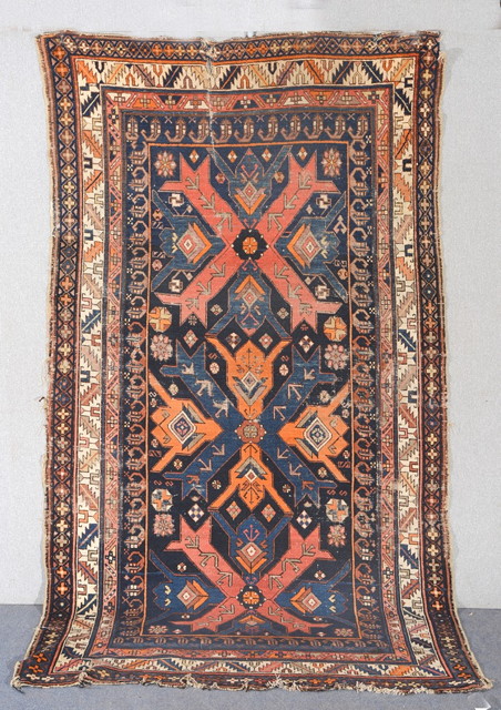 Appraisal: A CAUCASIAN BLUE GROUND RUG with interlinked geometric medallions in