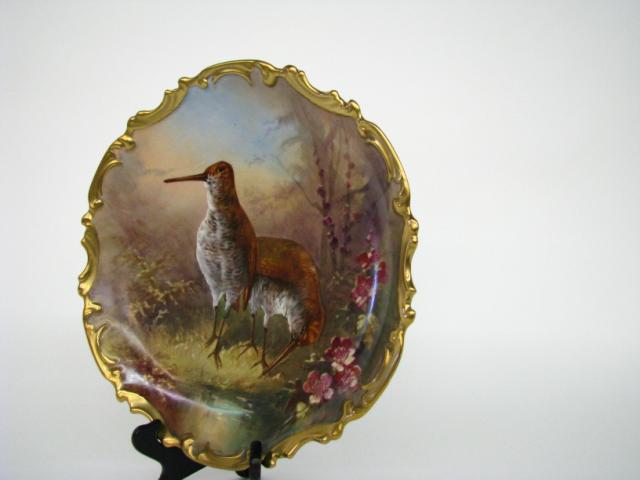 Appraisal: Antique European porcelain bird charger gold decorated edge hand painted