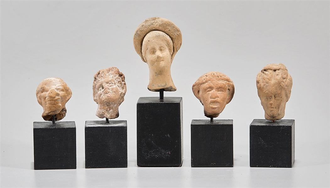 Appraisal: Group of Greek ceramic heads depicting females a Nubian and