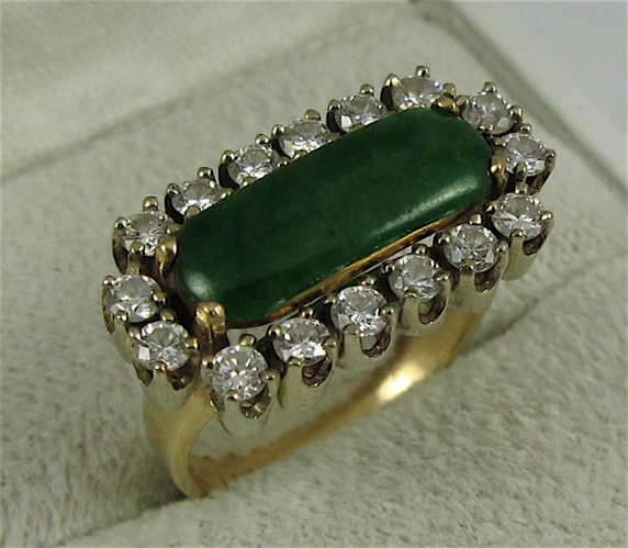 Appraisal: JADE DIAMOND AND K GOLD RING centering an oval green