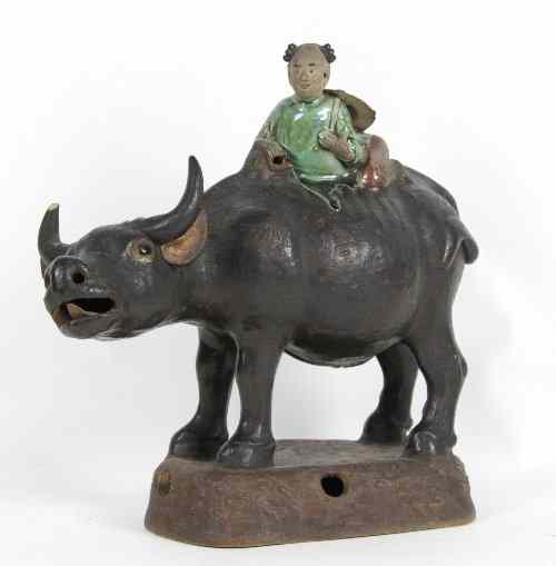 Appraisal: A Chinese pottery figure of a boy riding a buffalo