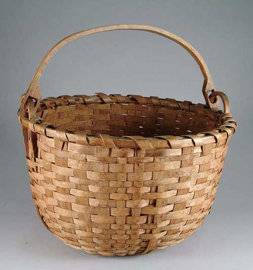 Appraisal: SWING HANDLED ROUND BASKET Carved wood handle splint basket has